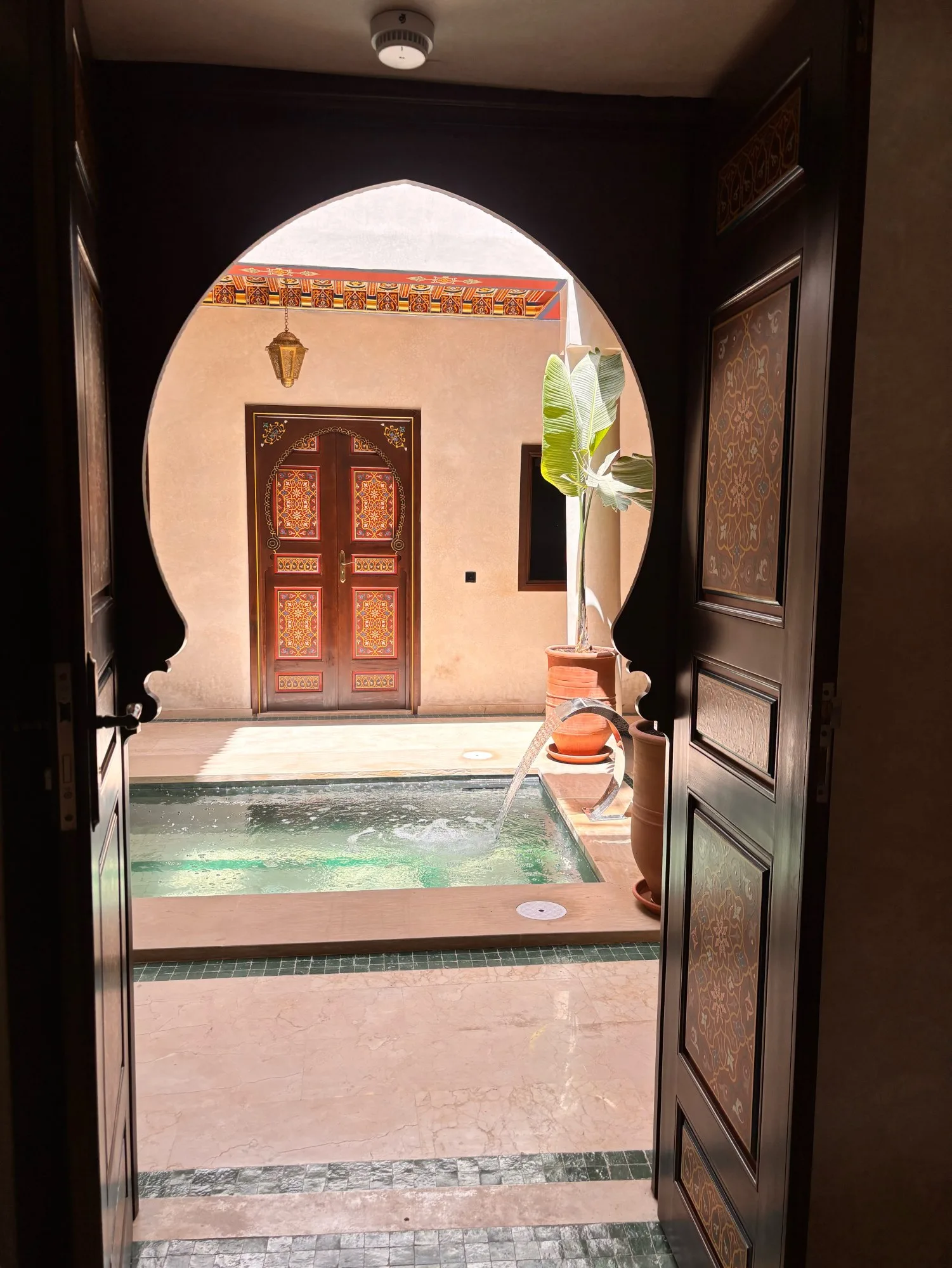 Hand-painted door open onto the patio and its plunge pool