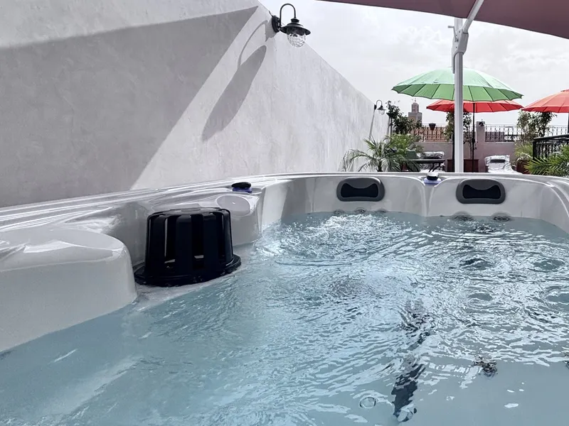 The heated rooftop jacuzzi under the parasol, the Koutoubia in the distance